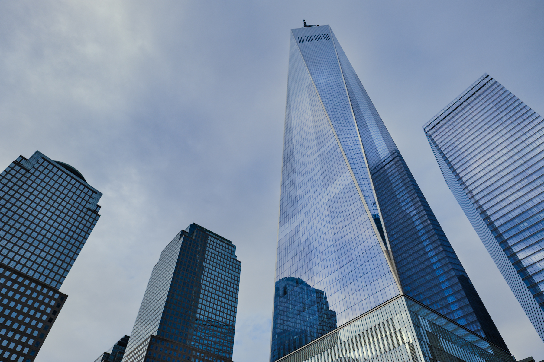 The beautiful blue sky and clouds reflected off of the glass skin of The World Trade Center Tower.