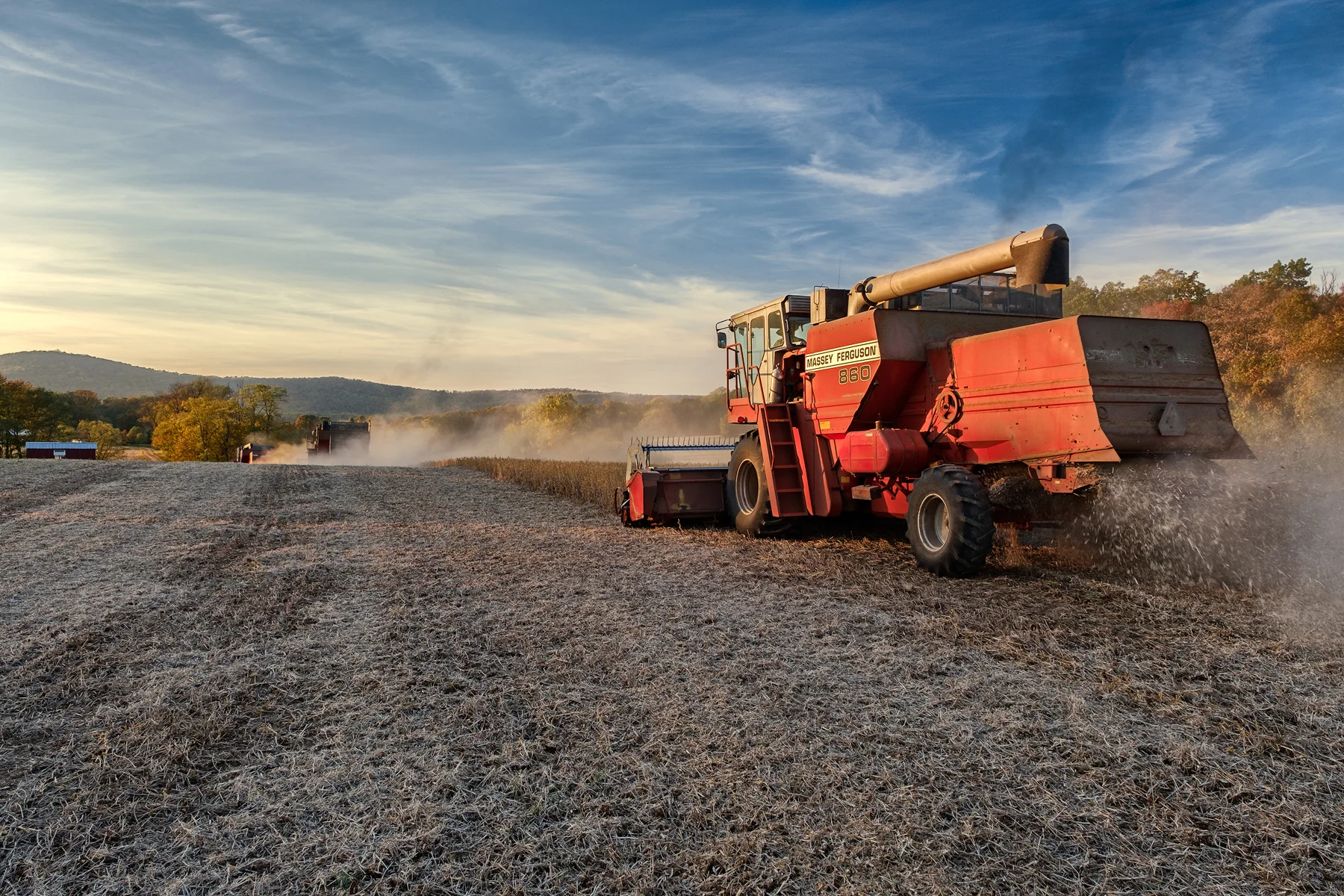 The three combines move past my position kicking up dust and kicking out the chaff from the threshing operation. Fuji X-Pro 2 and a Fujinon XF16-55mm at 16mm. Image exposed at ISO 400 at f5.6 for 1/60 of a second.