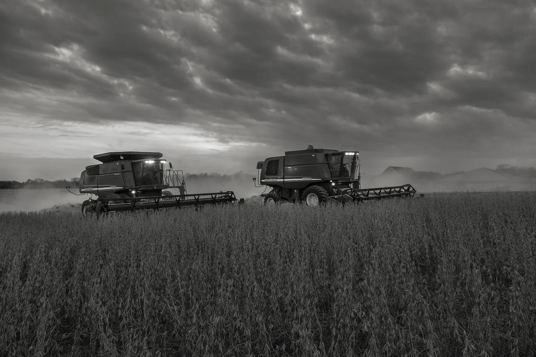 Combines harvest soybeans under a deepening twilight sky. Fuji X-T2 and a Fujinon XF16-55mm f2.8 WR at 23mm. Image exposed at ISO 800 at f4 for 1/60 of a second.