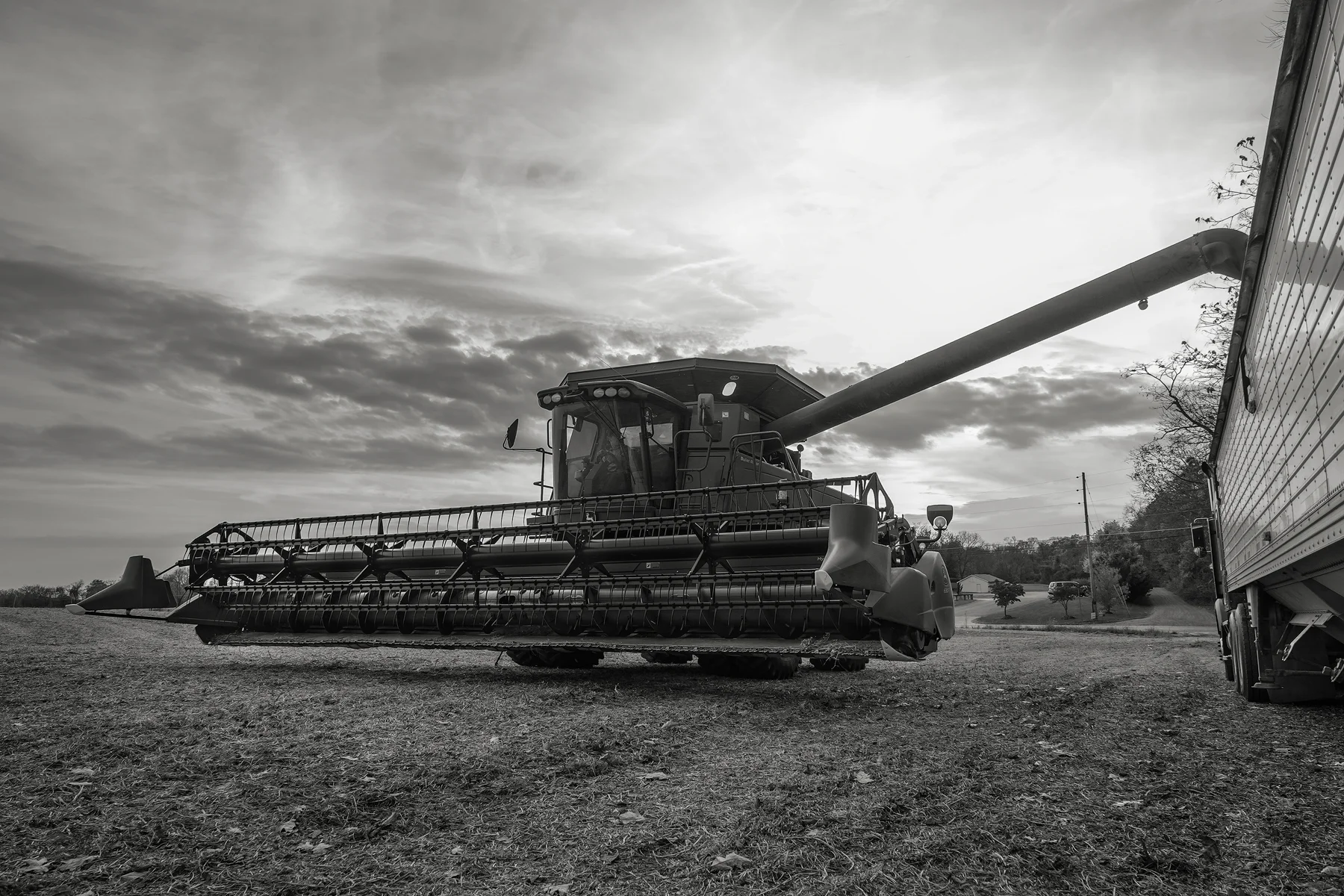 The setting sun backlights a combine as it unloads soybeans. Fuji X-T2 and a Fujinon XF16-55mm f2.8 WR at 16mm. Image exposed at ISO 800 at f5.6 for 1/100 of a second.