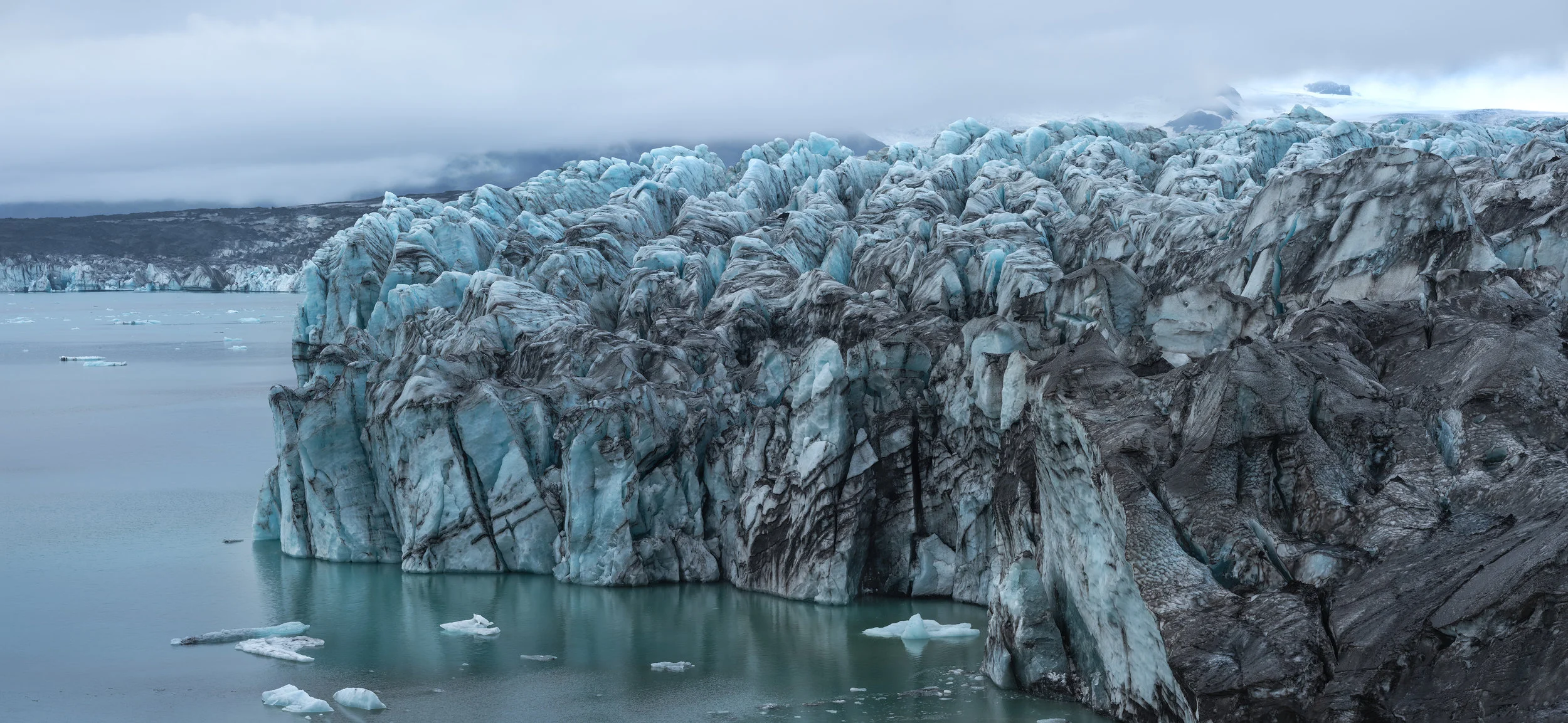 The ice calving site at Breiðamerkurjökull features huge seracs of blue-green ice.