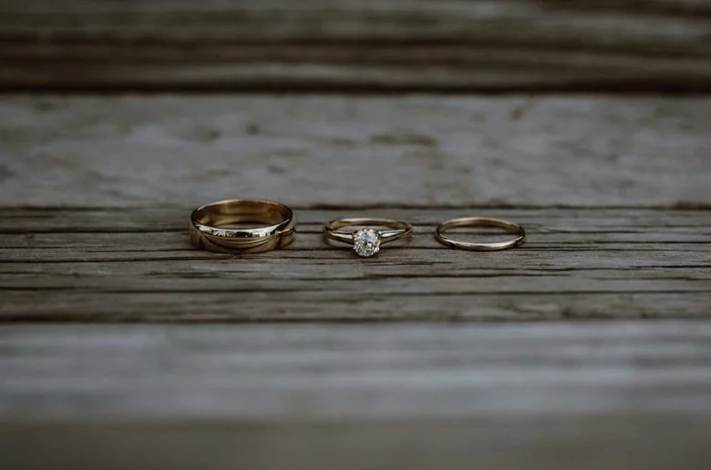 Rings by Keileigh & Ponny: 14k yellow gold, 5mm and 1.5mm polished half round bands with her antique engagment ring. Photos by: Catalina Jean