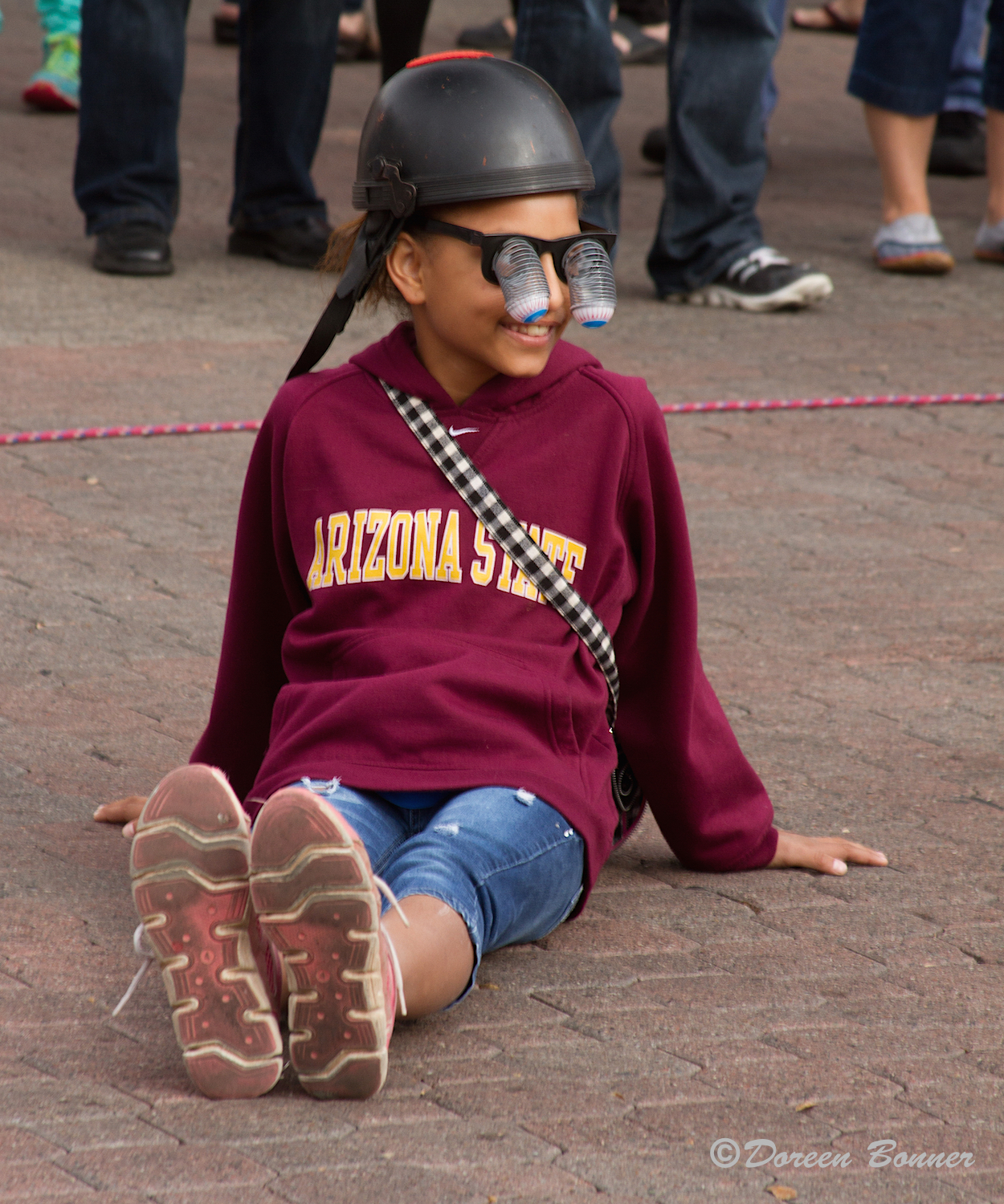 Doreen reports that this young girl is an audience volunteer to throw up the juggling pins to the unicyclist. He gave her the hat to wear. She was cute and did a terrific job.