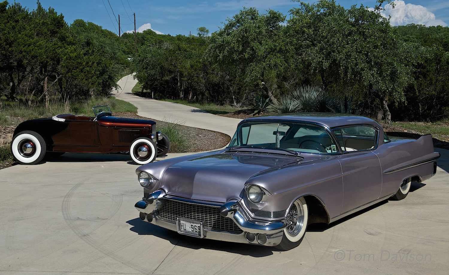The back car is a 1931 Ford roadster and the front car is a 1957 Cadillac, owned by Steve the show's promoter.