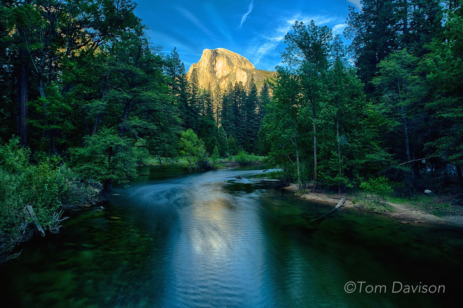 This is an image of Half Dome taken from Sentinal Bridge. This is the most common spot for taking shots of Half Dome. We were told to check out the spot along the river from Parking Lot A. We liked it better. Either place collects photographers at sunset and it is a good idea to stake out your place early. Half Dome stays lit long after the foreground goes dark. It is not gold every night as we see in photos taken by others. It can be a dull gray with only a yellow tinge.