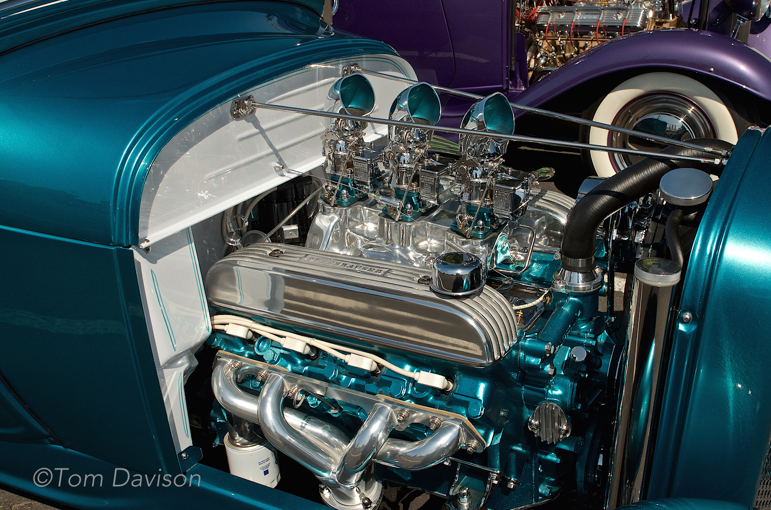 A Buick V8 powering a Model A roadster, done in the style of a 1960s-built showrod. This stuff gets rather technical and Tom appreciates the nuance . . . I just like the color a lot and like the way it pays attention to detail such as painting the inside of the carburetor induction scoops (that is why they call it a showrod).