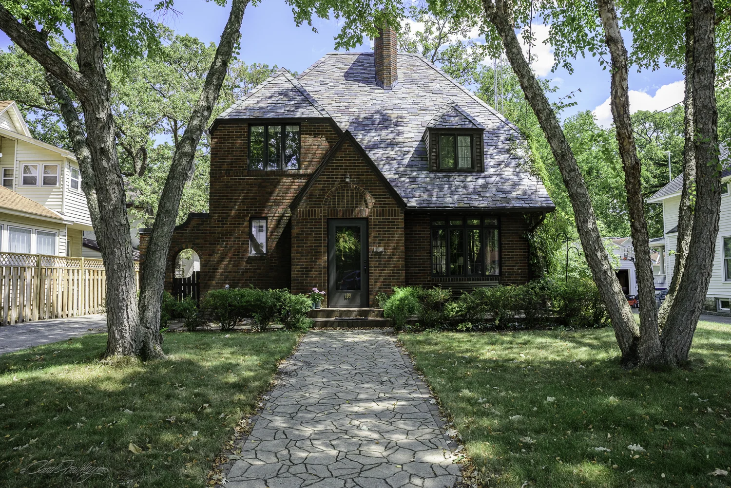 This is called the Temple House and is an example of Tudor Revival. It was built in 1929. The roof is made of slate. Sometimes the ownership history is interesting. The house was built by Mr. Temple. He owned the print shop in Mason City that printed all the billboards for Ringling Brothers, Barnum and Bailey and other circuses.