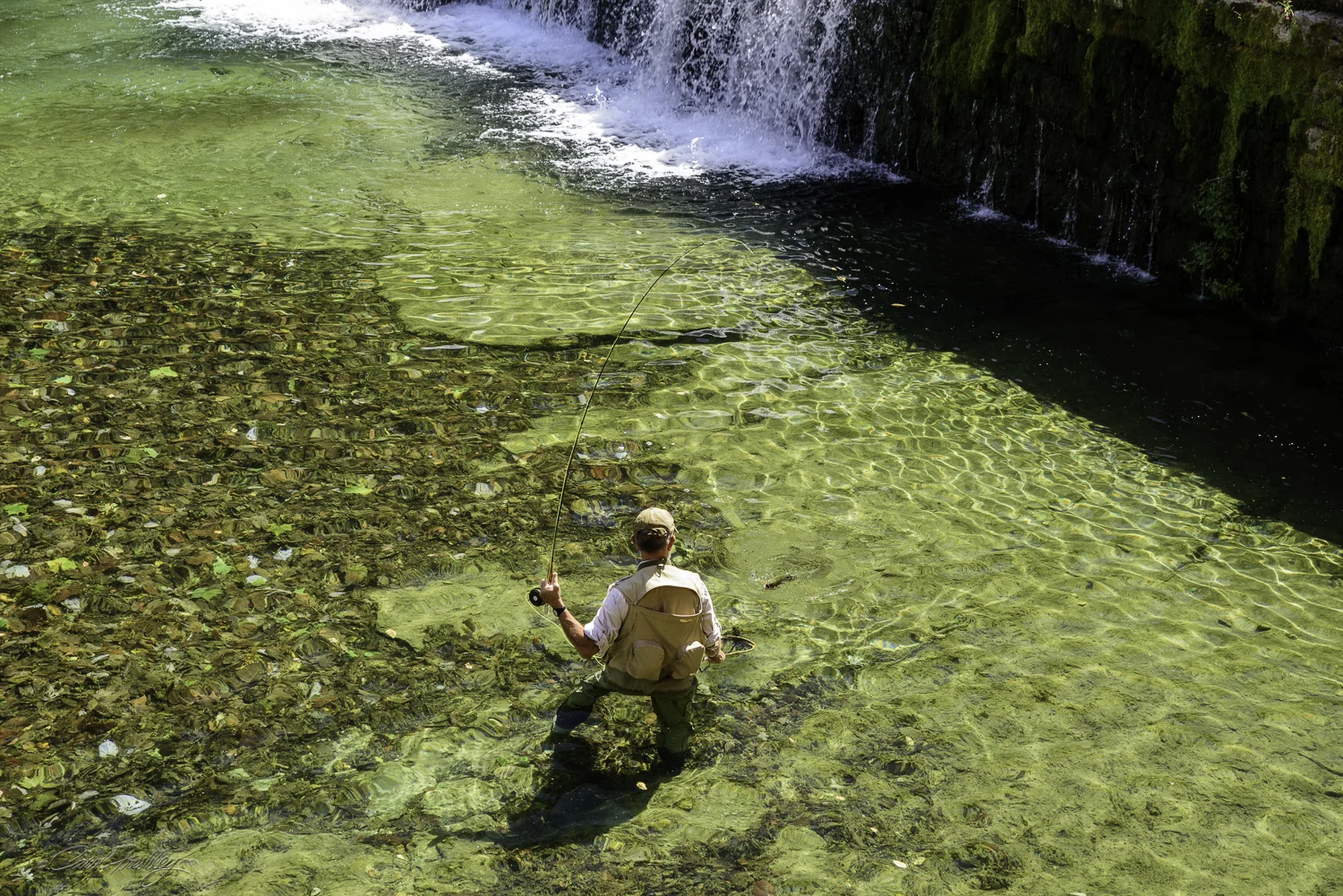 He has his net ready. Can you spot the trout?