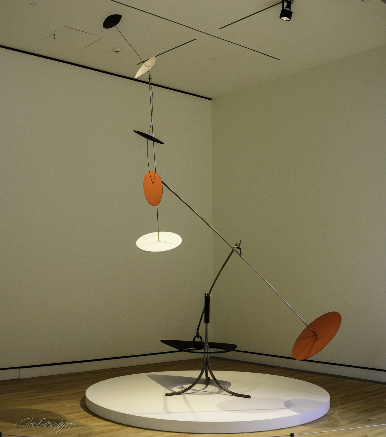 This mobile by Alexander Calder (1898-1976) is a classic example of Calder's standing mobiles. Made of painted sheet metal, Trois noirs sur un rouge (Three Blacks over Red) , 1968, achieves graceful balance in motion. Calder, ''challenged the traditional definition of sculpture as three-dimensional mass, creating works of art made from metal rods and biomorphic sheet metal planes that move with the air in varied and spontaneous paths."