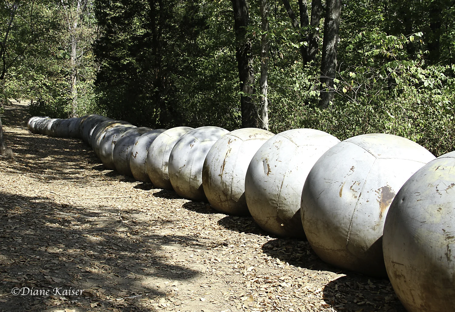 Ball? Ball? Wall? Wall? , by Donald Lipski, 1994, 55 marine steel buoys.