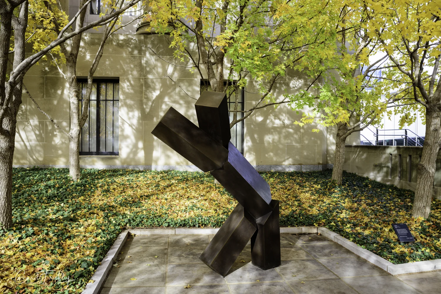 "This simple, geometric forms of Joel Shapiro's sculpture suggest the human body in motion. Untitled appears from certain views to have two upraised arms and one leg extended, as though taking a bow or preparing to do a cartwheel. Its open form activates the surrounding space and invite the viewer to strike a similar pose. Joel Shapiro, Amerian born 1941, cast in 1992 of bronze.