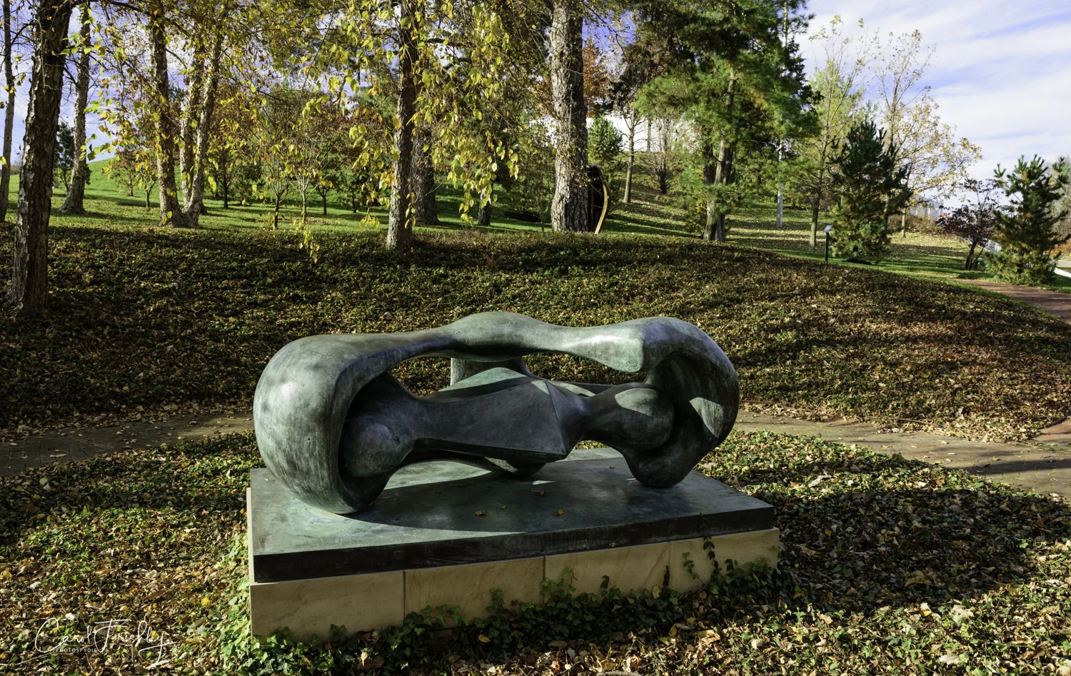 Another Henry Moore sculpture, Reclining Connected Forms, 1969 of bronze. "Although abstract, this sculpture is an example of Henry Moore's basic themes, that of mother and child. The configuration of the sculpture suggests a maternal figure containing a childlike form within her protective embrace.