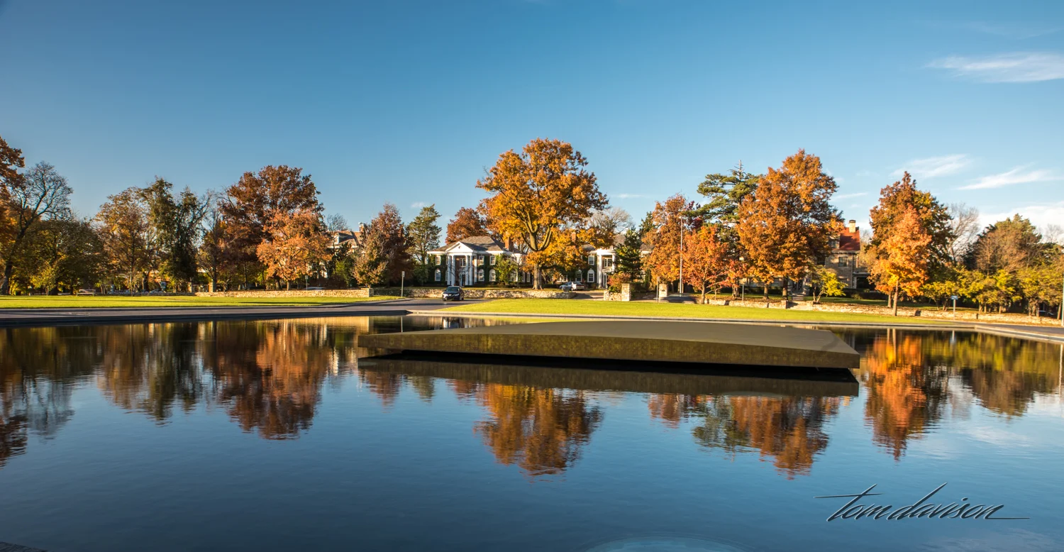 The island in the middle of the reflecting pool is actually a statue! It is Walter de Maria's One Sun / 34 Moons, a bronze and stainless steel, neon illuminated sculpture that "lives within time and timelessness. The gold-leaf rectangular Sun shines during the day, constantly reflecting the dance of actual sunlight and clouds overhead. At night, the 34 Moons, encircled by silvery white neon, emit a mysterious glow. Related to the cycles of day and night, the seasons and the heavens, One Sun / 34 Moons takes on cosmic and mythic proportions."