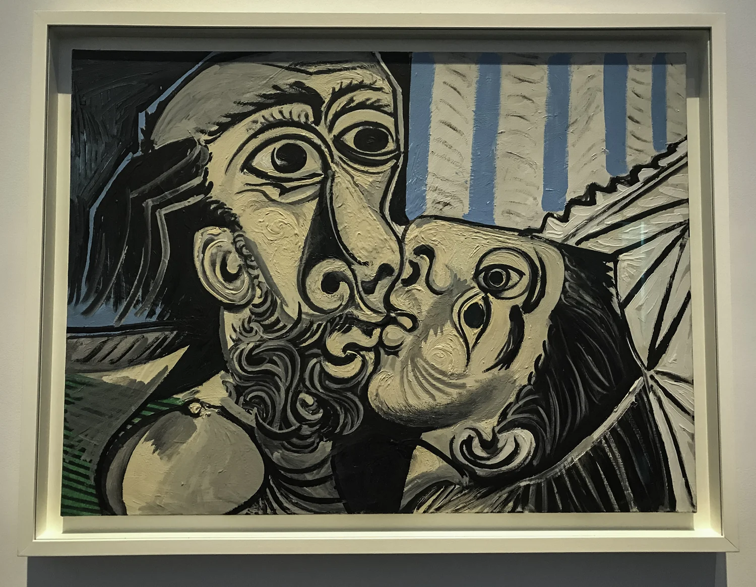 The Kiss , oil on canvas, 1969. "Locked together, two heads are joined by a single line that swirls around the entire canvas. Out of two people, Picasso made one figure, reinforcing the intimate fusion that takes place in and ardent kiss. He did not hesitate to reshape the faces to fit closely together, and he gave enough details to suggest this depicts the artist and his second wife, Jacqueline Roque. Even in their tender embrace, both have their eyes wide open, as if sharing a revelation."