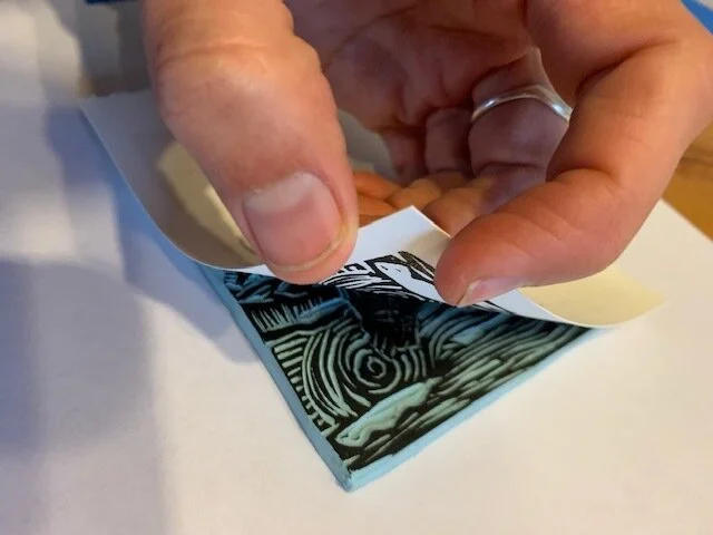 8. I check to make sure that the design has registered enough onto the paper by carefully lifting a corner. If it hasn’t, I replace the edge and burnish again.