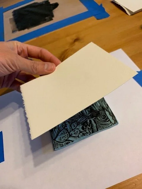 6. Usually, I use two hands to do this, but I had to take a photo with my other hand. I carefully position the paper over the block and then lightly press down in the middle to adhere it to the ink and hold it in place.
