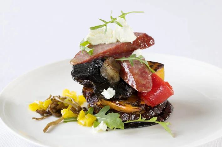 Canape of roasted artichoke, mediterranean vegetables & Chorizo sausage topped with Meredith persian fetta