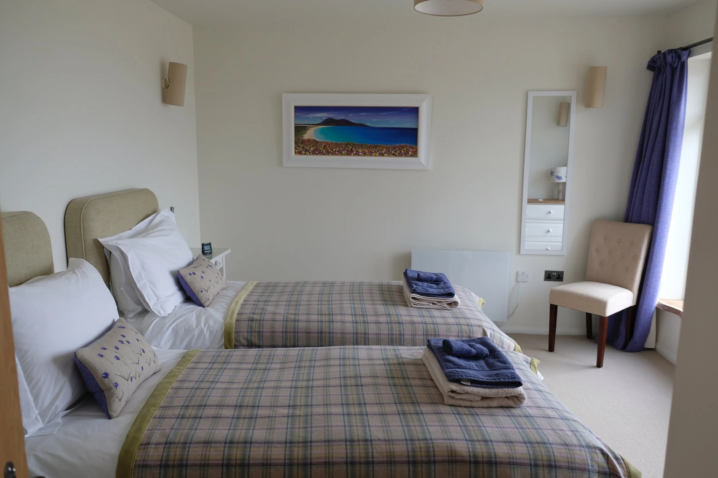 The room features Hope Blamire's original painting of the machair in full flower at Scarista, with the beach and Chaipmaval in the background - very appropriate as you can see the real scene from the window!