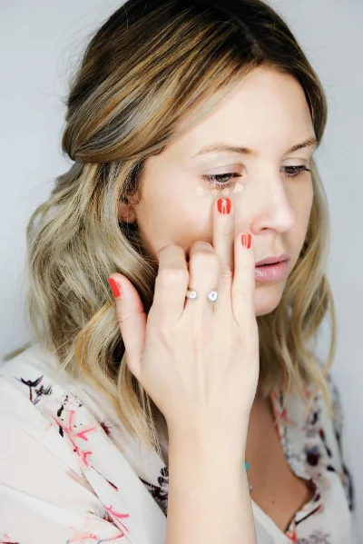 Using your ring finger again, tap out the concealer and make sure to blend it into the foundation so there are no harsh lines.