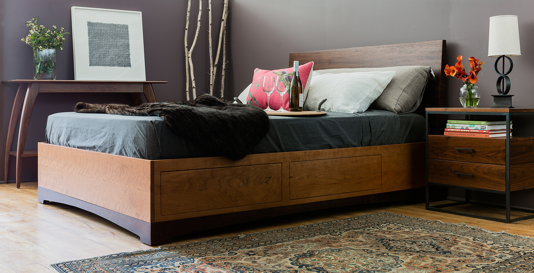 Eastern Console shown in walnut, the Modern Storage Bed in cherry and walnut, queen size & custom steel nightstand.