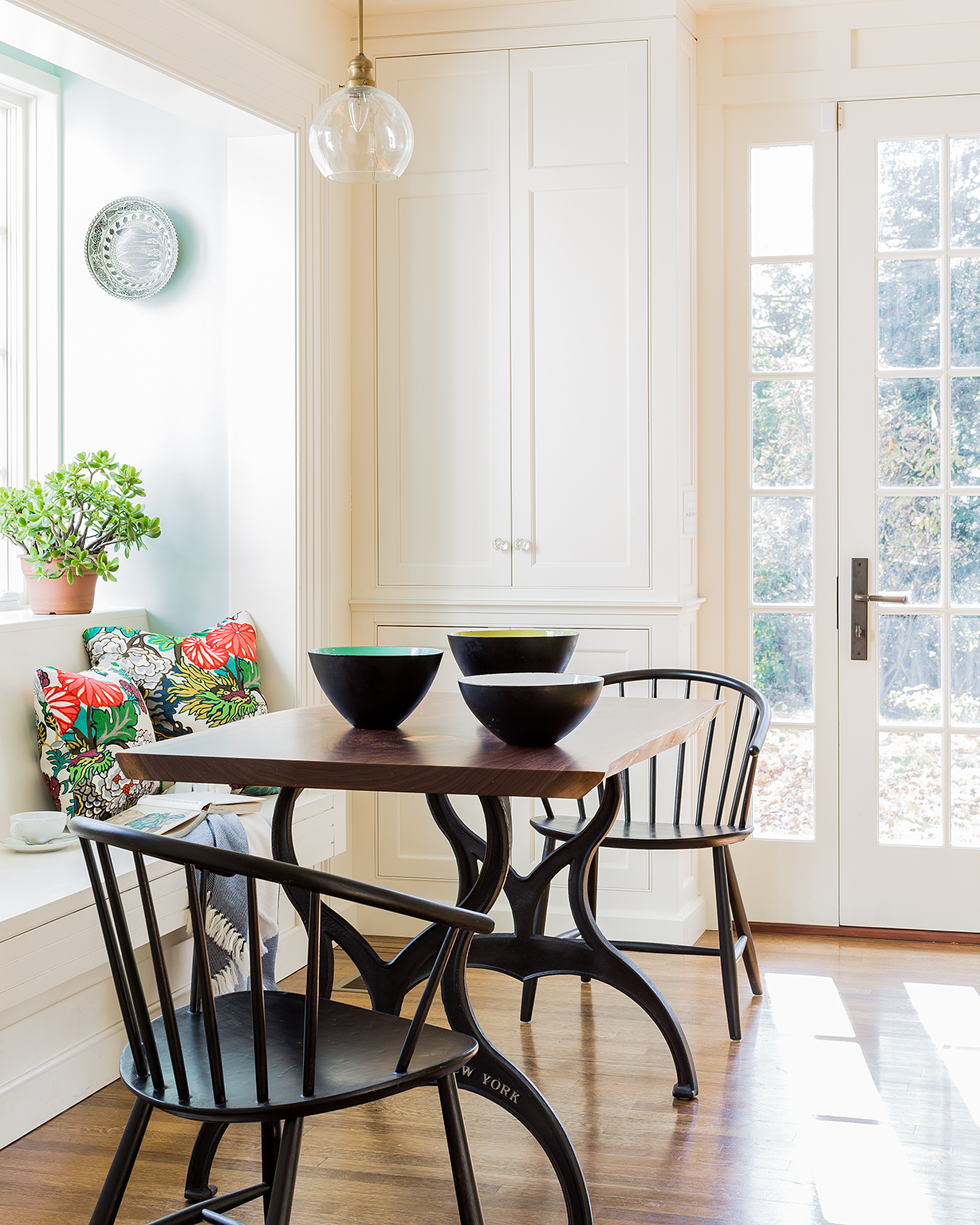 Cambridge Kitchen, painted built in cabinetry and walnut slab table with steel base. Pillows available in our store, chairs and bowls from Reside.