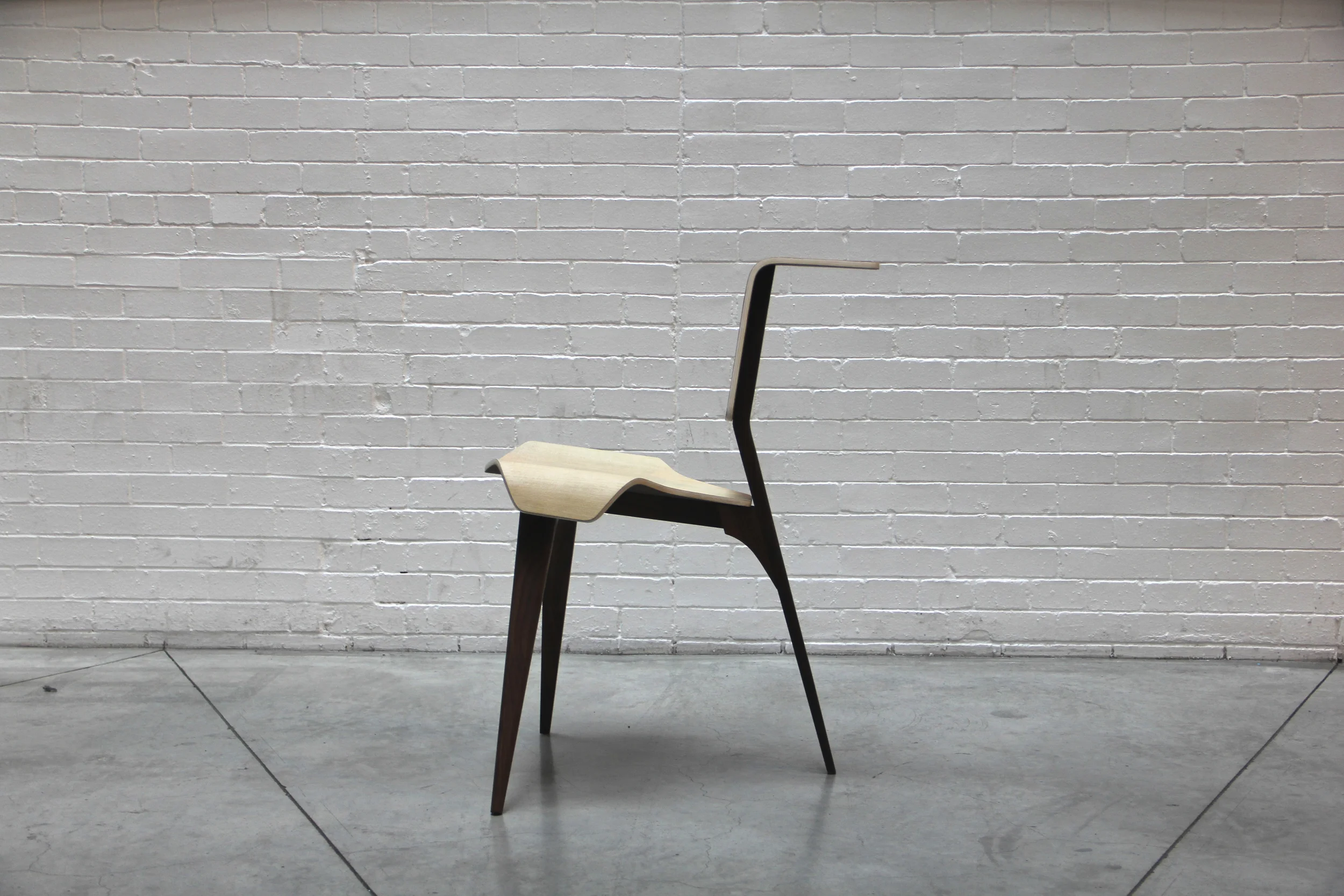  The open space from three legs allows users to use the object in any orientation while the subtle curvature from the back affords a work surface or arm rest. The simplified form affords users different positions without any movement from the chair. 