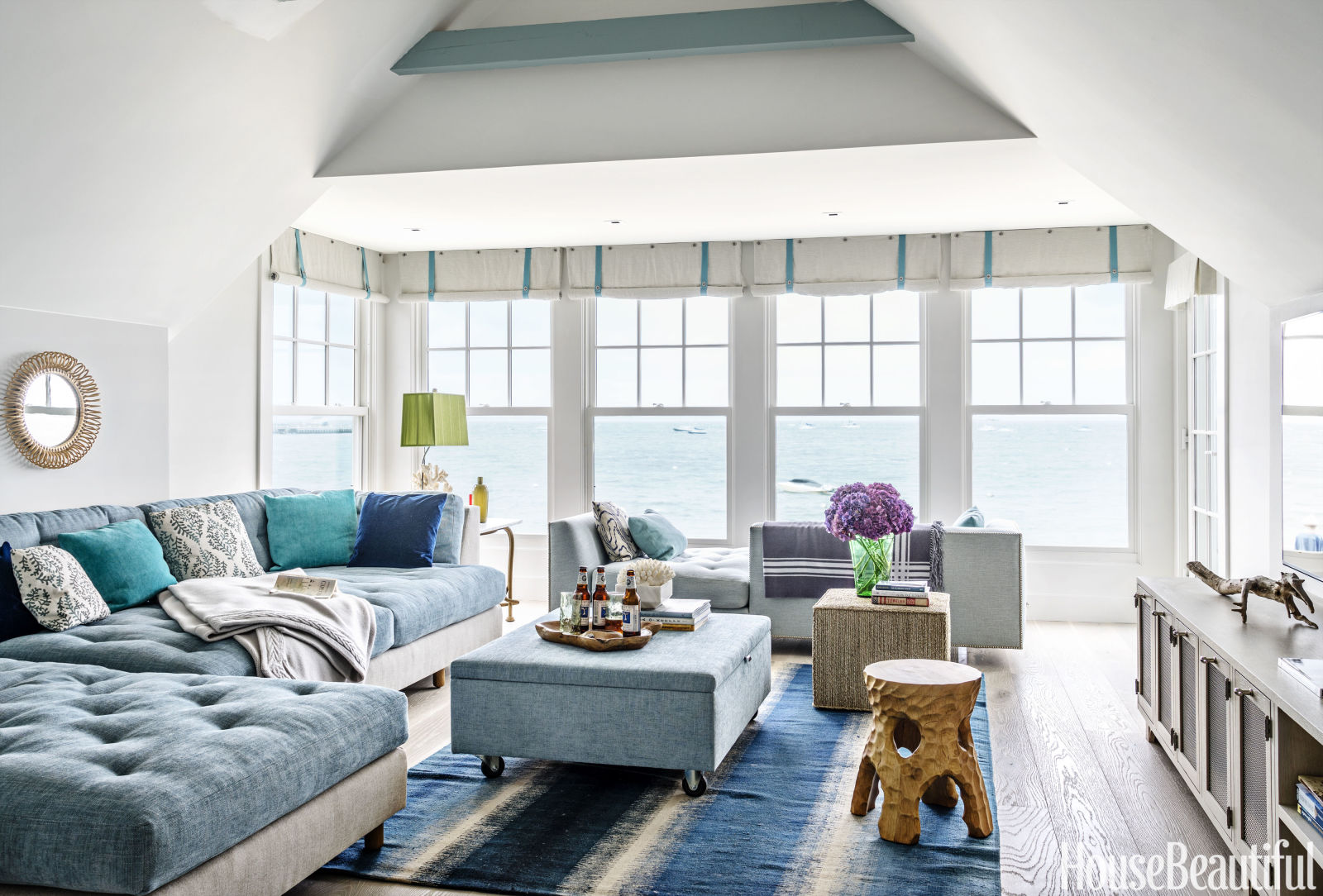 The sitting room upstairs looks so relaxing in this muted blue palette. I love the old fashioned roll up window treatments.