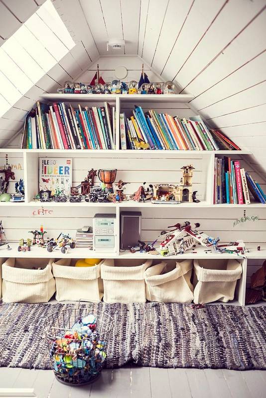 It doesn't look like they did much to turn this attic into a playroom. Just a coat of paint on the existing wood board walls and floor. Very cute, rustic and functional! Image via Domino