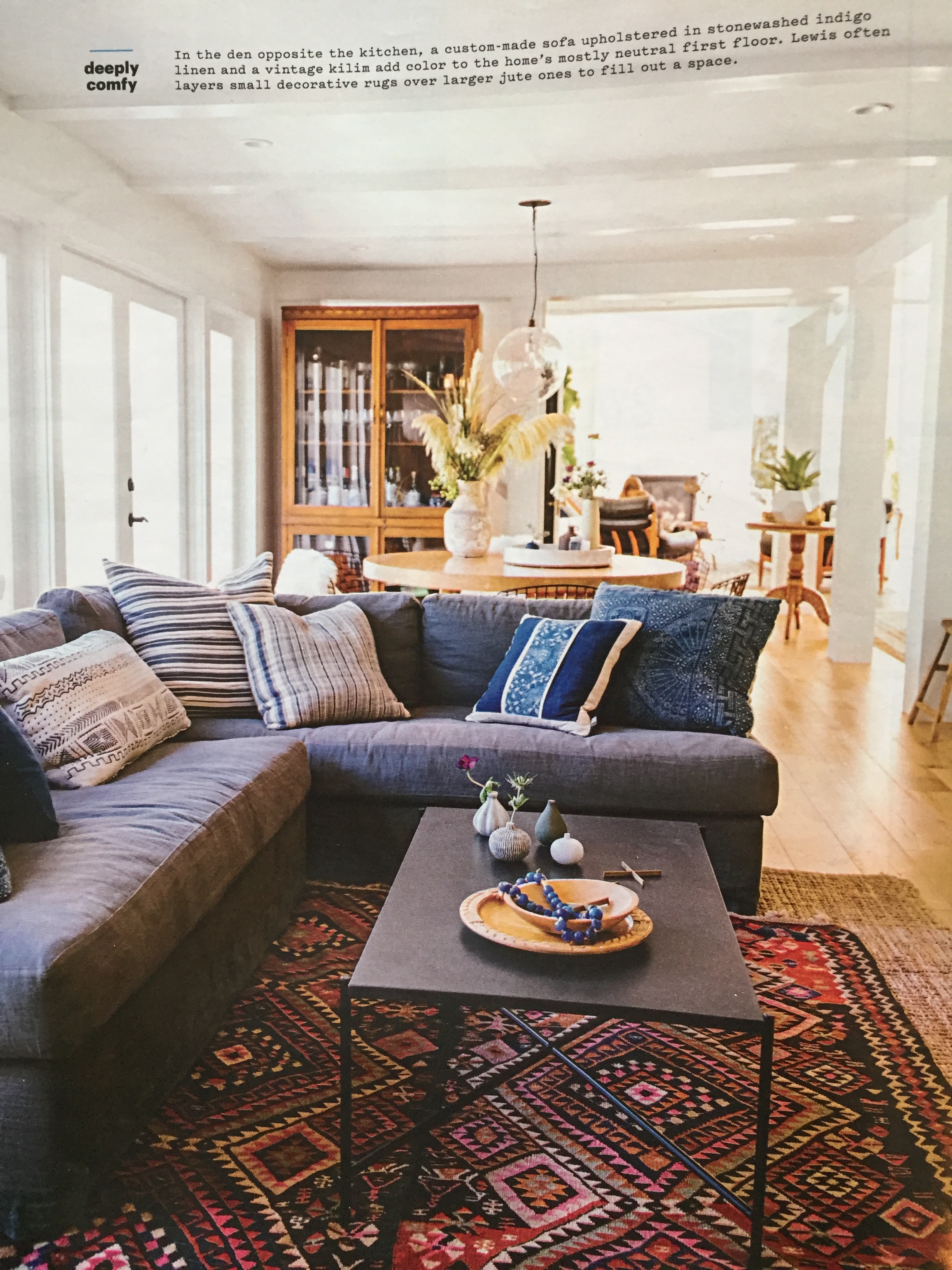 I love the casualness of this custom sofa in a linen that looks like a denim. A layered rug look is always a great way to add texture to a room.