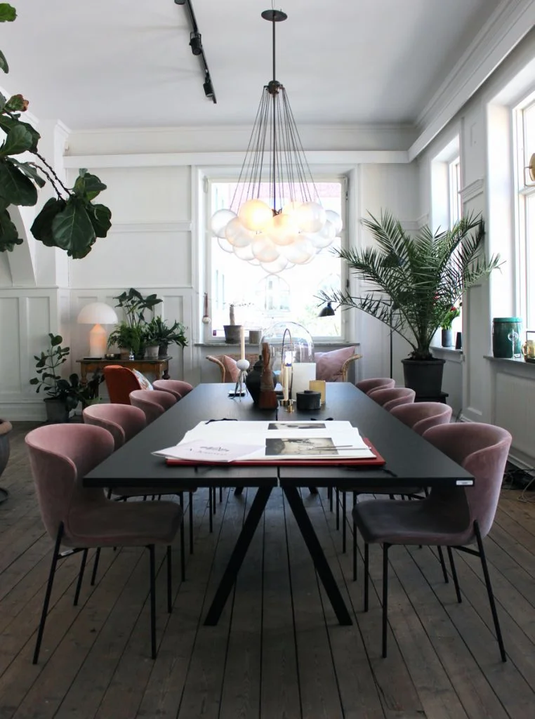 A more modern use of the color lavender, this time in these sleek upholstered dining chairs. I love that this complementary color scheme only uses plants to incorporate the green opposite purple on the color wheel. Image via Remodelista