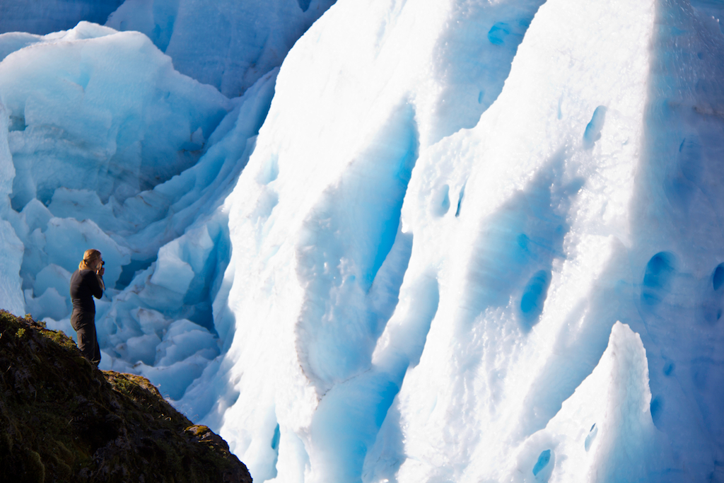 Conservation photographer Bridget Besaw at Melimoyu glacier, Melimoyu wilderness lodge, Patagonia Sur, Patagonia, Chile.