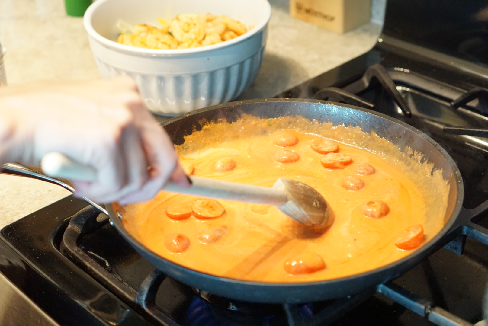 Simmering the tomato sauce with coconut milk, Brazilian spices, and tomatoes. So fragrant.