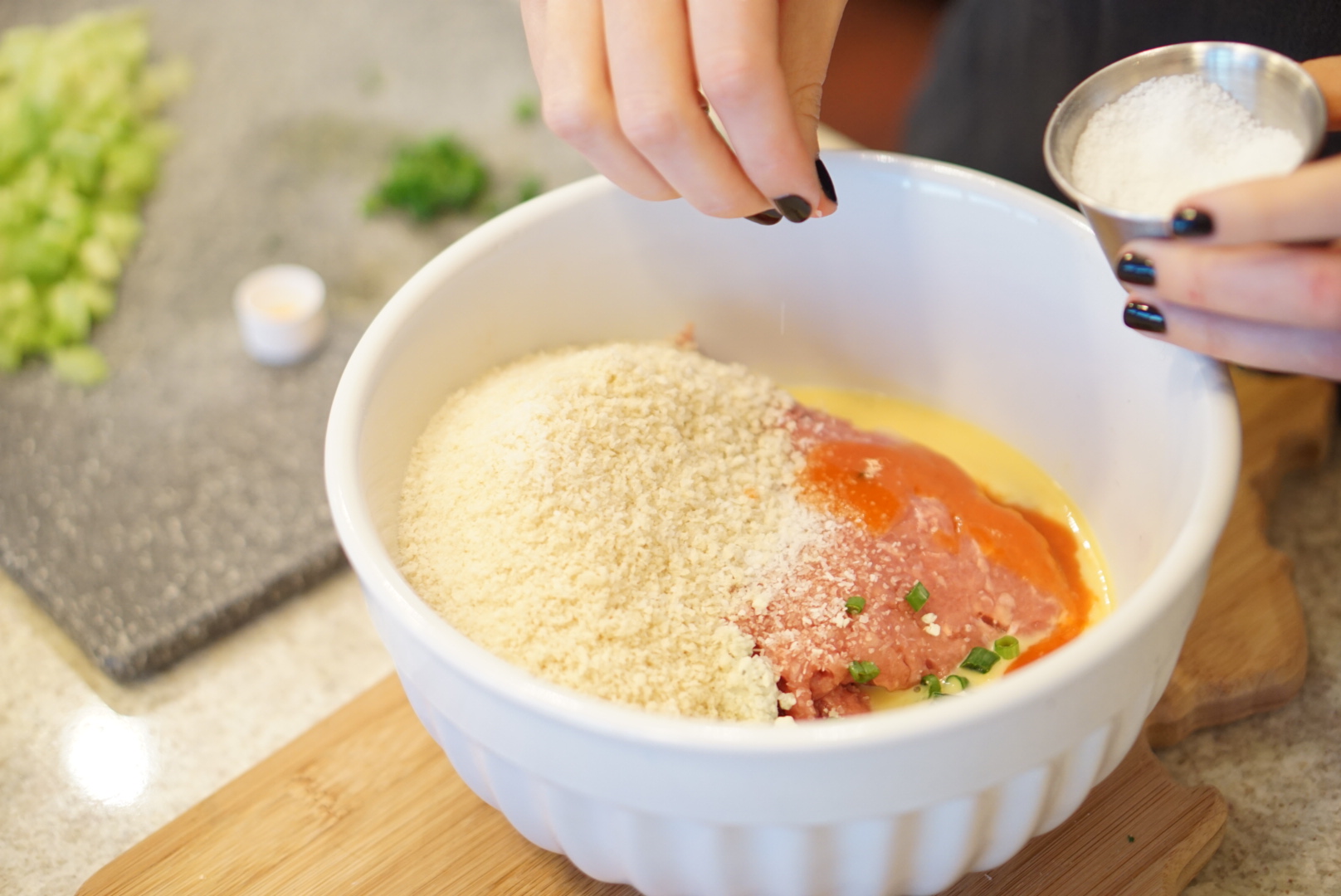 Mixing the turkey with panko, hot sauce, green onions, and egg. 