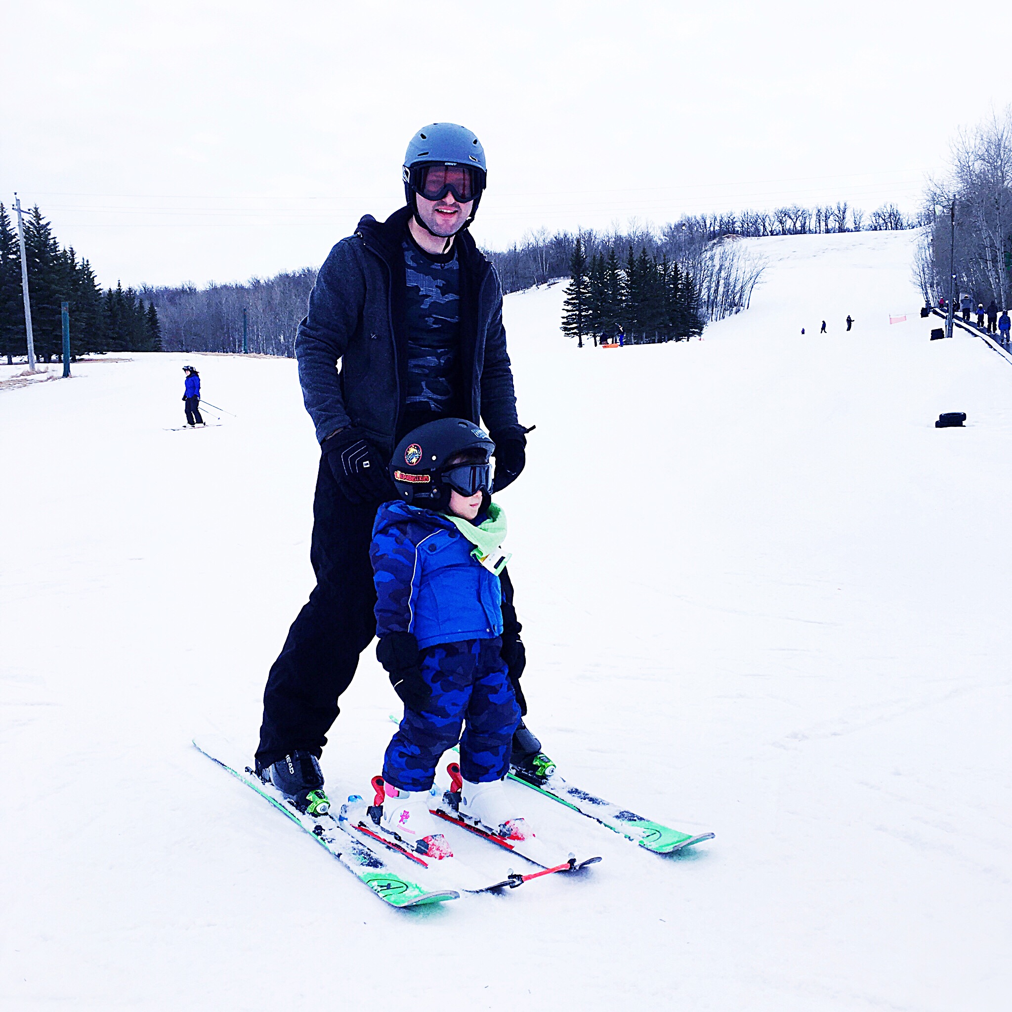 Proud Father and his tiny skier.