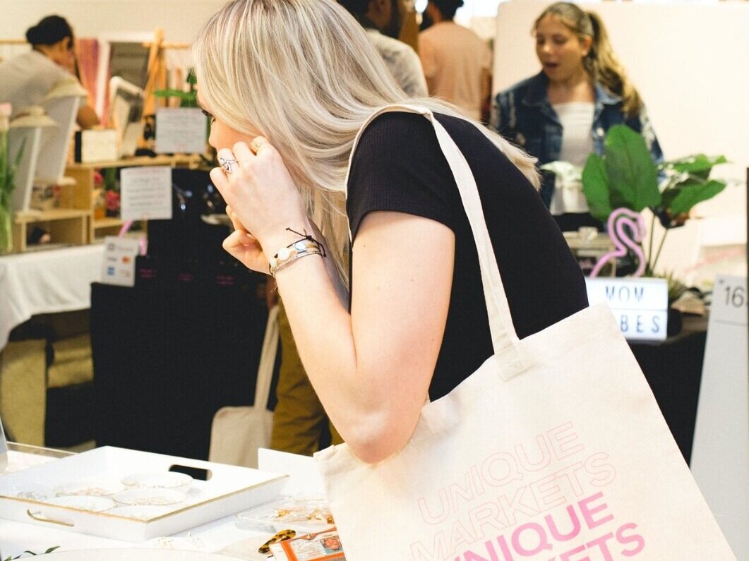 shopper with bag looking at earrings.png