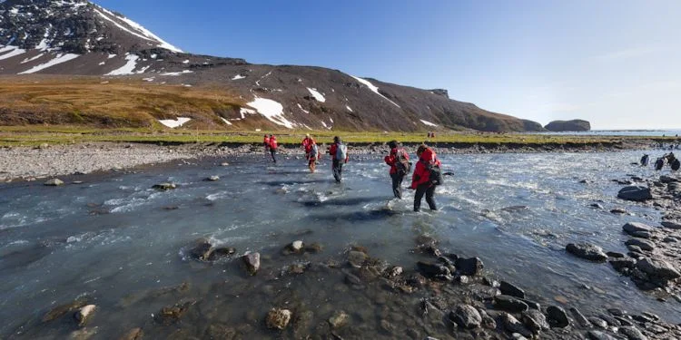 Passengers crossing the river