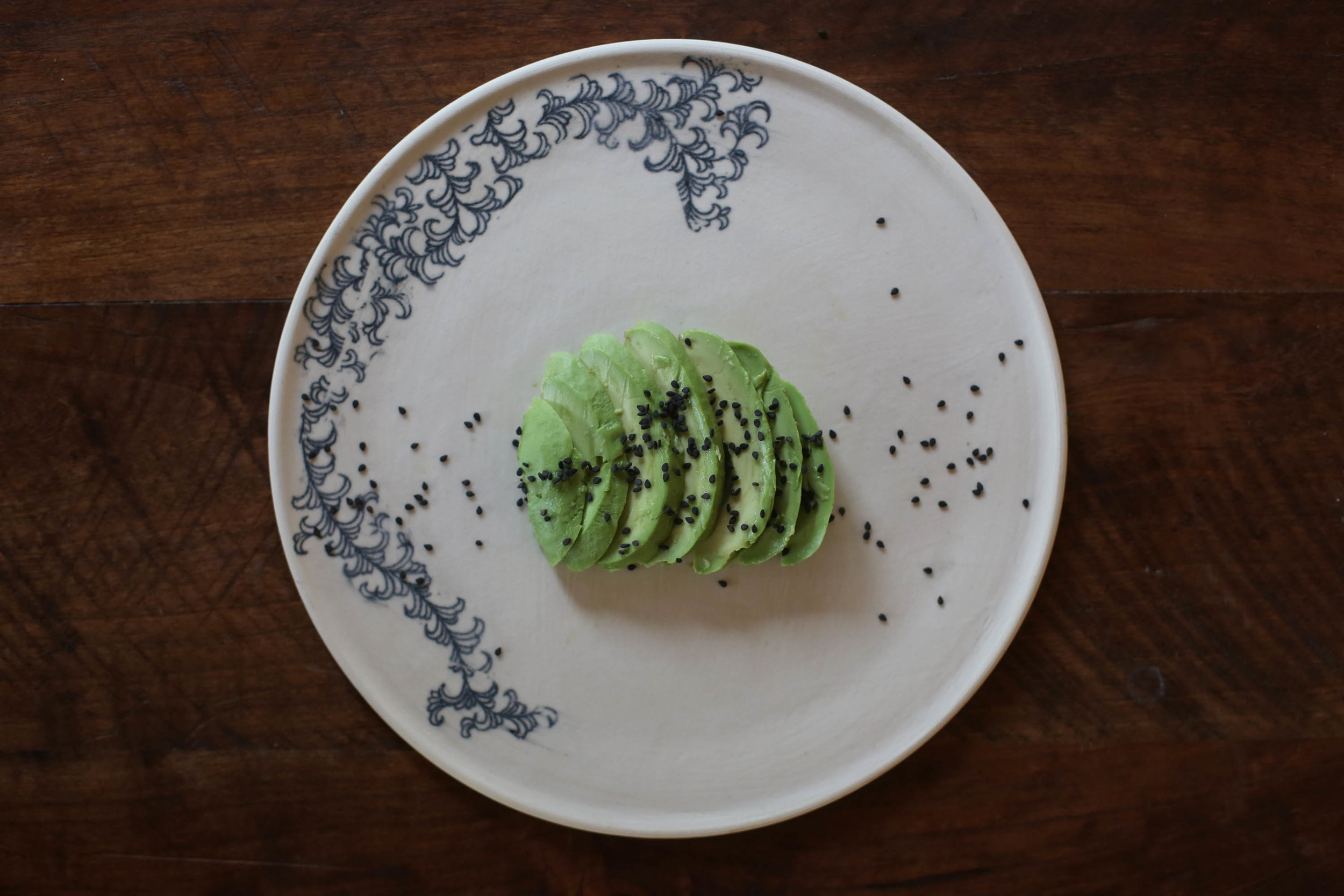 Sliced Avocado with sesame seeds.