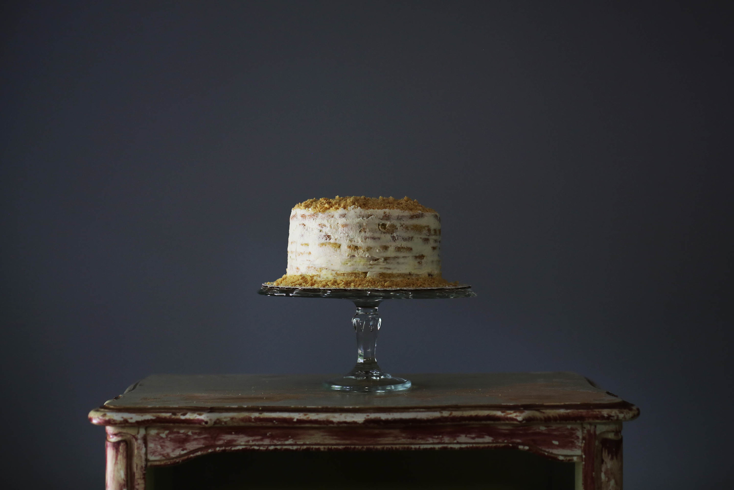 a naked key lime cake with a graham cracker garnish