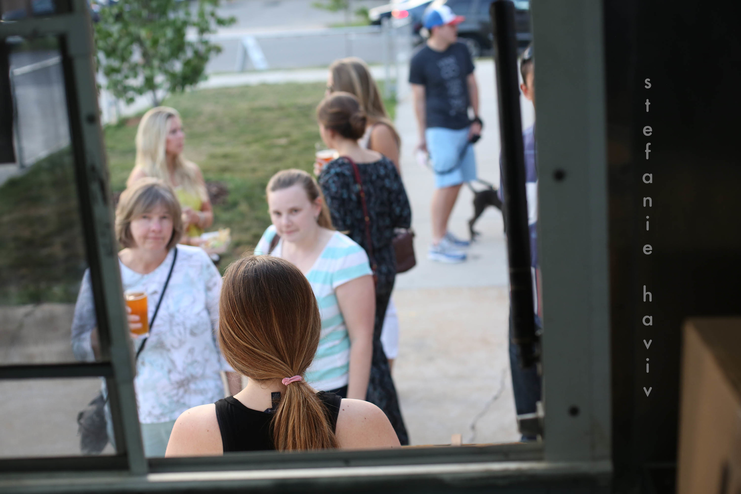 a line forming, beer in hand
