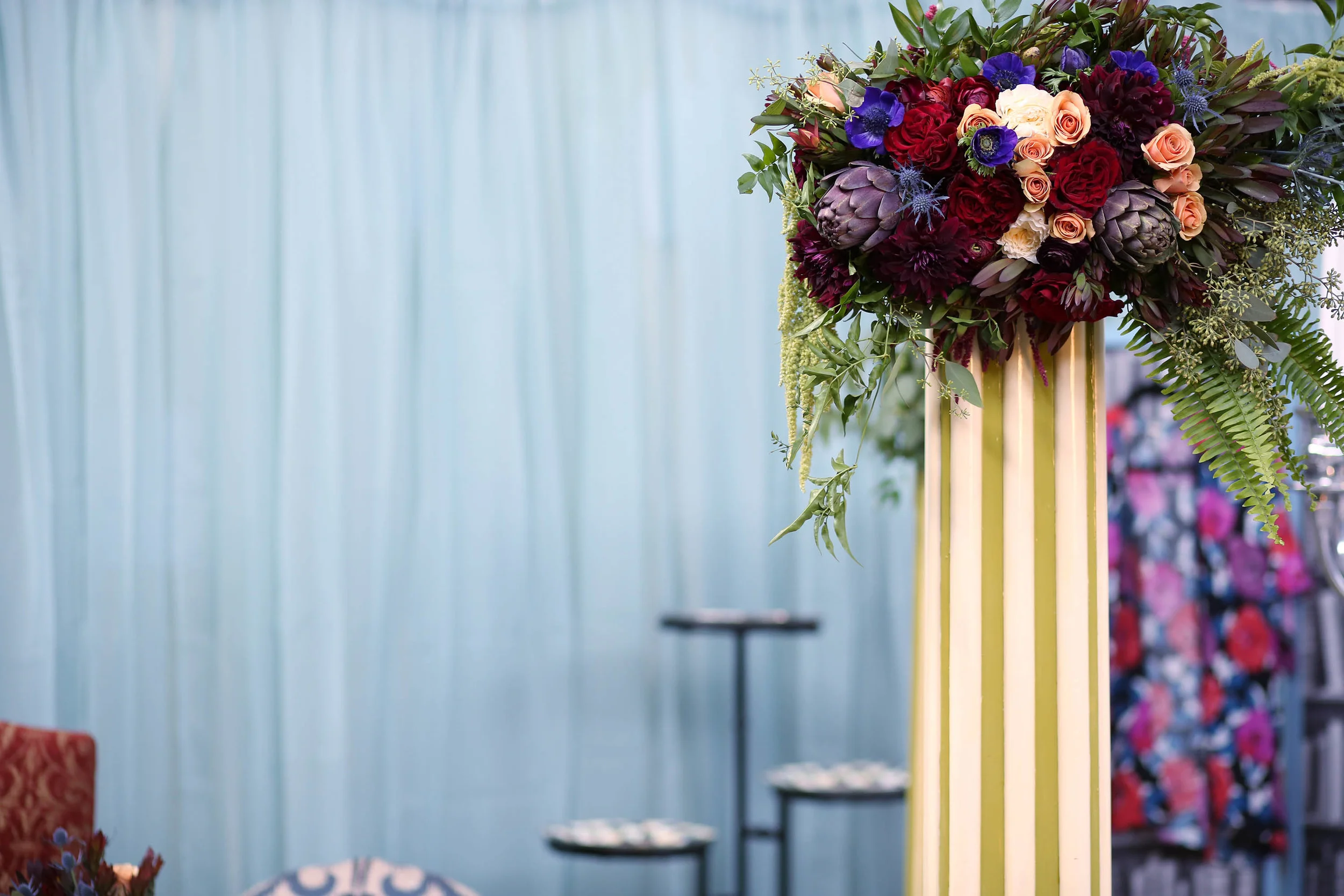 Julie killed it with the flowers. Cascading bouquets for the columns.