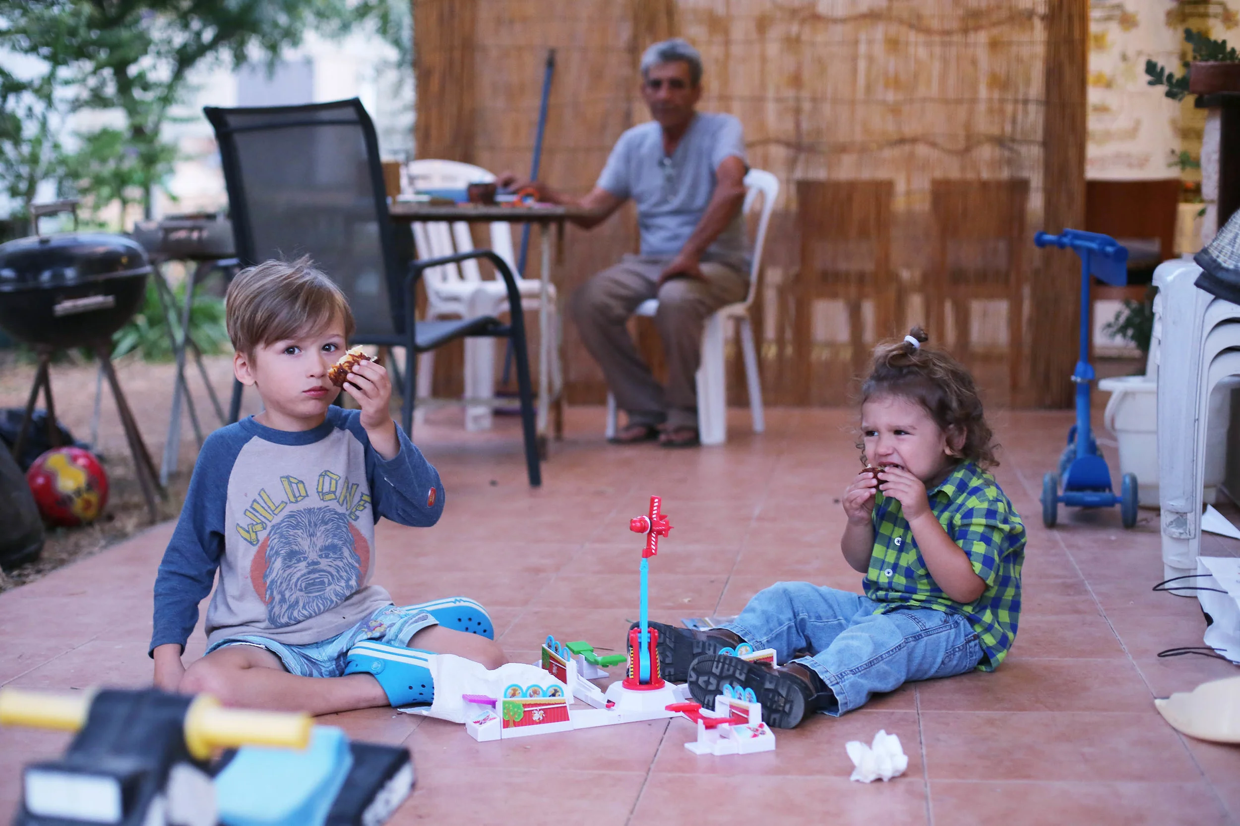 The boys enjoying latkes before dinner in the Sukkah. Elroy was not into sharing.