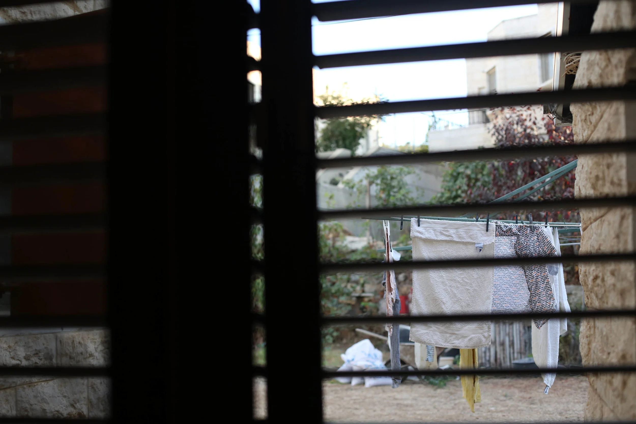 From our bedroom window, the smell of fresh laundry cascades through the shutters. 