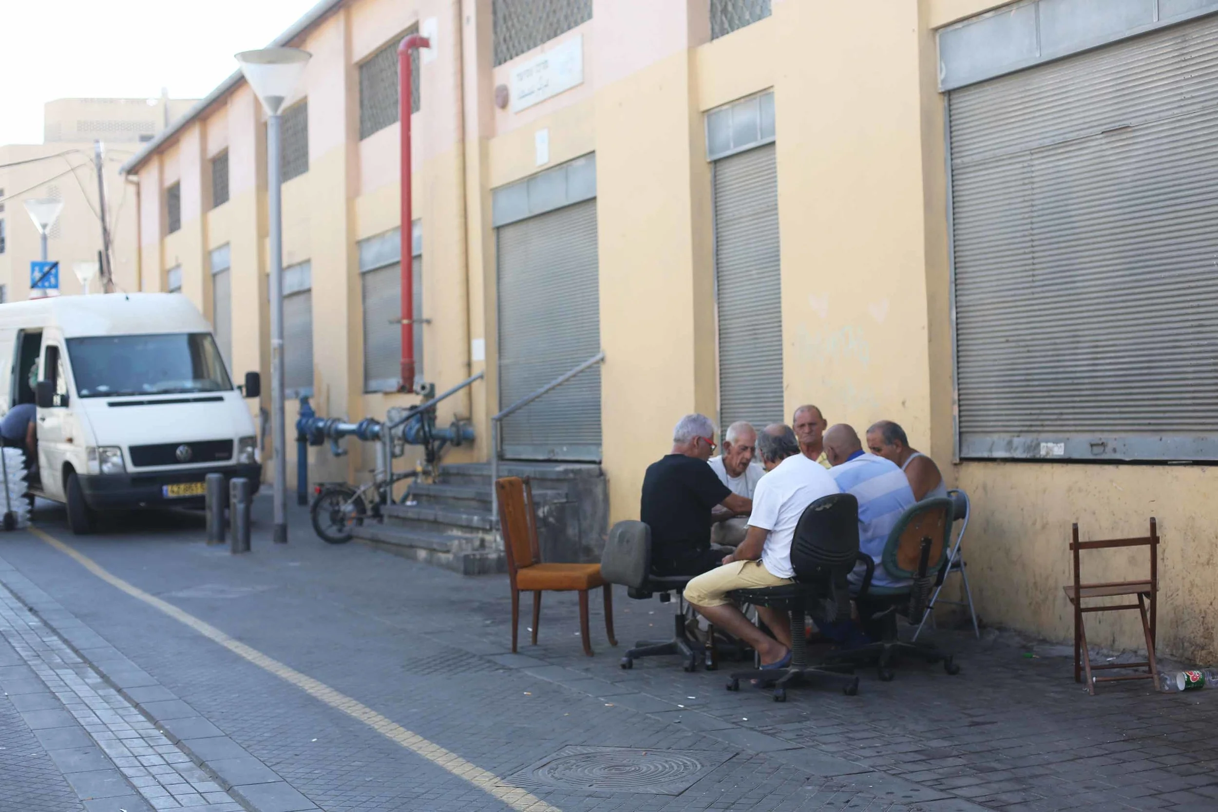A classic image of men playing cards on the street.