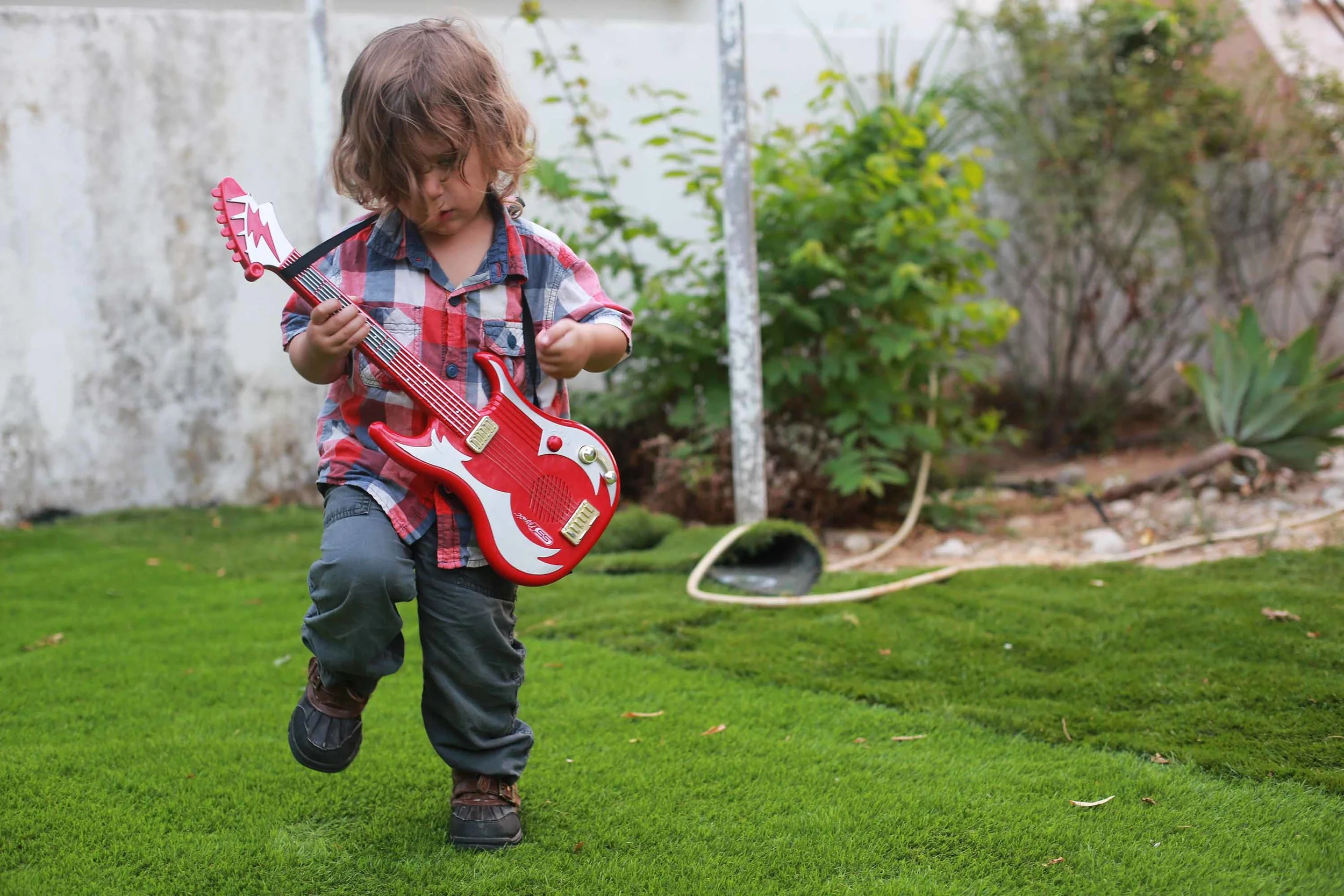 little E rockin out on the astro turf.