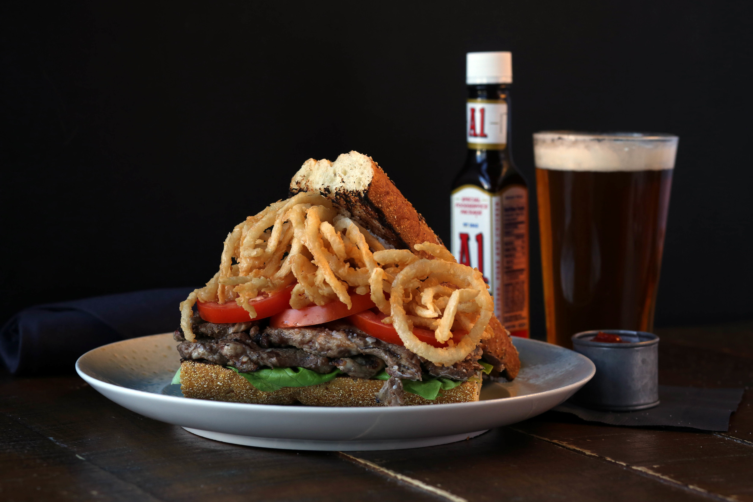 steak on toasted baguette with onion rings. Yes please!