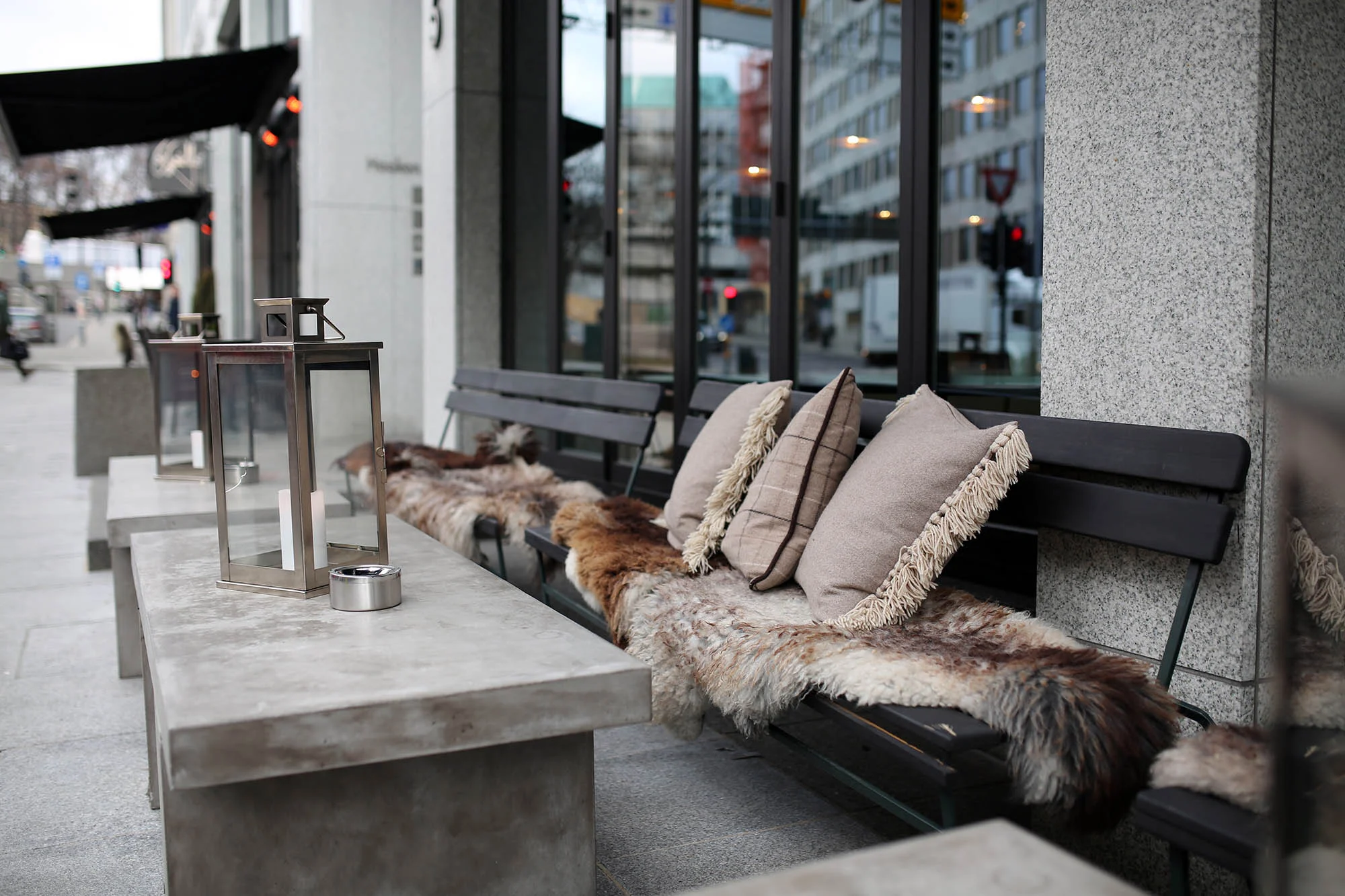 In order to encourage outdoor seating and people watching, most restaurants and cafés put out pillows, fuzzy pelts and blankets for their guests to enjoy.