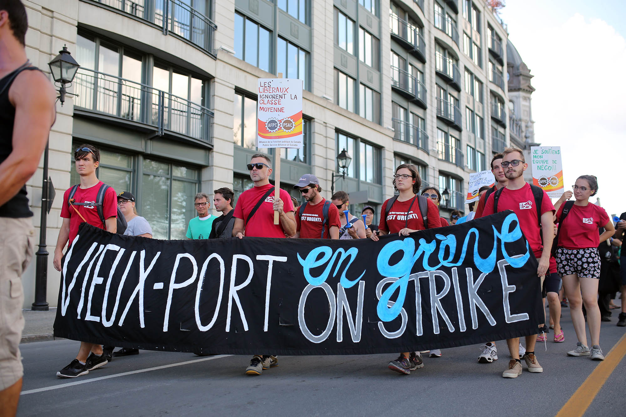 the staff at the old port were on strike. they peacefully marched along the street with a police escort.