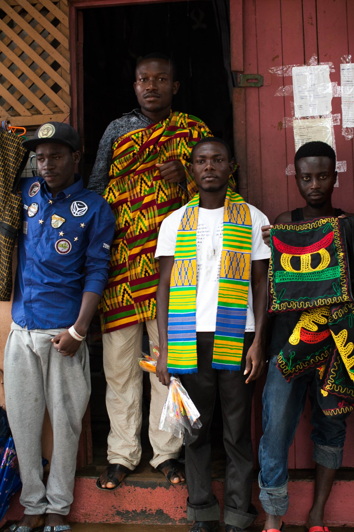 Enterprising weavers post up outside the loom house.