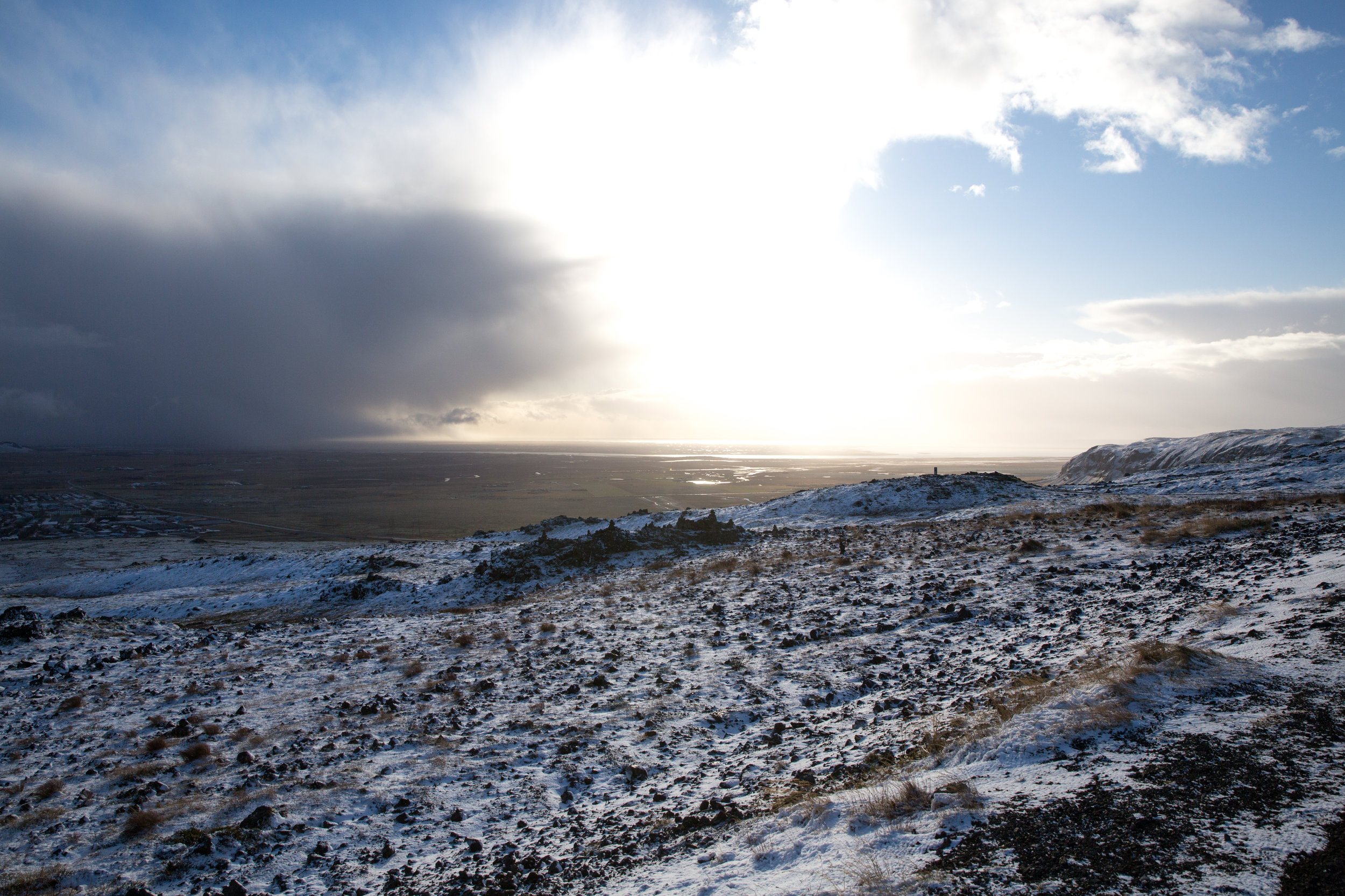 Looking to the southeast near Hveragerði, before decending into the primary stretch of the southern RIng Road. The sun shines much brighter, warming you even through your windshield. Speaking of wind, its intensity allows storms to roll in quickly and with little warning. Coupled with that and a sun that only lives in the South, the day length felt more akin to something out of The Elde Scrolls series.