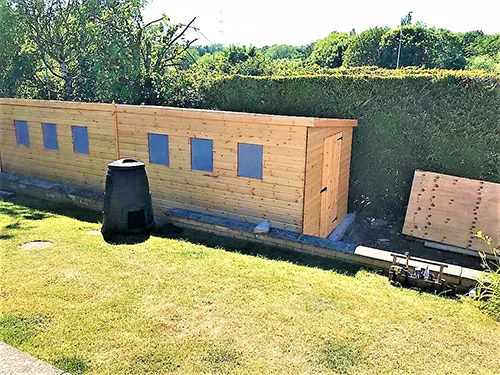 We make custon built sheds to suit your needs as in the picture were a specifically built workshop was require to fit into a restricted area of the garden that was light enough inside and the access point at the only side available.